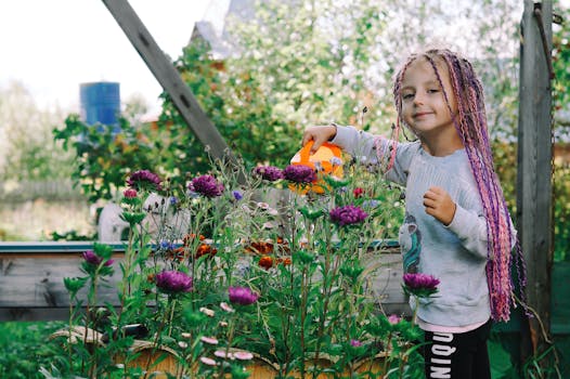 children watering plants in the garden