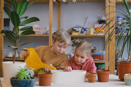 children watering plants in containers