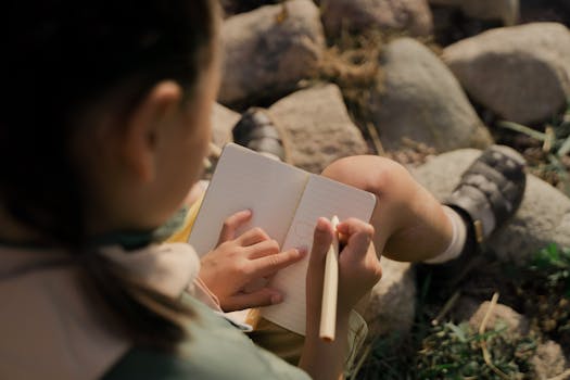 children drawing in garden journals