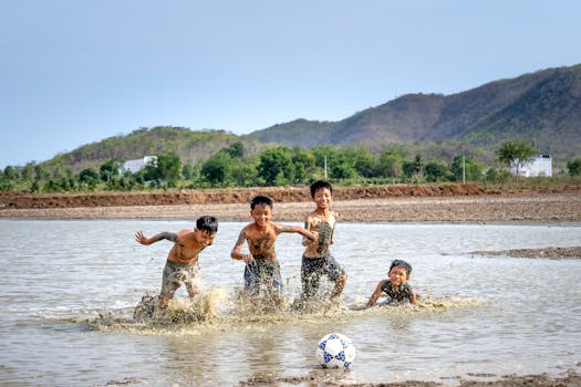 kids playing mud soccer